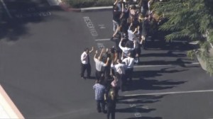 A still image from a video footage courtesy of Nbcla.com shows people lining up as first responders respond to shooting at the California Department of Developmental Services Inland Regional Center, one of 21 facilities serving people with developmental disabilities, in San Bernardino, California 