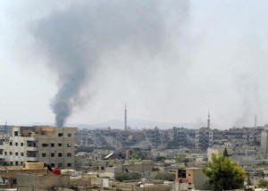 Smoke rises from the besieged Damascus suburb of Daraya, before rebels and residents start being evacuated under an agreement reached on Thursday between rebels and Syria's army, 