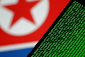 Binary code is seen on a screen against a North Korean flag in this illustration 