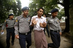 Detained Reuters journalist Kyaw Soe Oo is escorted by police officers as he leaves the Insein court in Yangon, Myanmar