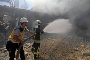 Firefighters battle a blaze after an airstrike in Jadraya, Syria